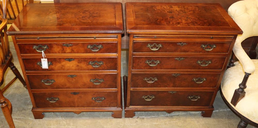 A pair of Georgian style banded walnut chests, each fitted brushing slide over four graduated long drawers on bracket feet, W.64cm, D.3